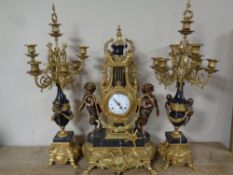 An impressive French brass and marble three piece imperial clock garniture