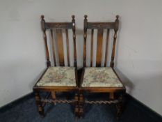A pair of Edwardian oak high backed dining chairs