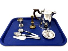 A silver plated water pot, a brass candlestick, plated egg cup, cutlery.