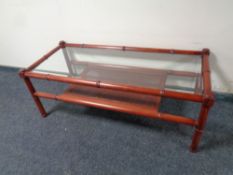 A bamboo and wicker glass topped conservatory coffee table with under shelf