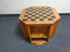 An octagonal oak Art Deco book table with chessboard top, height 43 cm, width 52.5 cm.