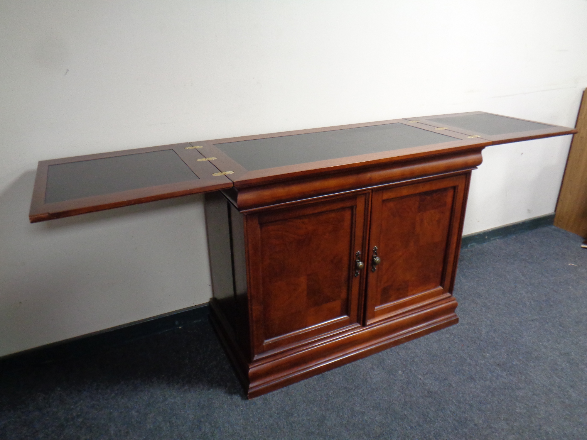 A contemporary cocktail bar/cabinet in a mahogany finish