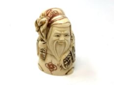 A carved Chinese bone netsuke,