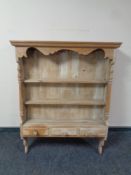 A stripped pine Delft rack fitted three drawers