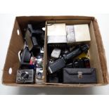 A box containing a quantity of vintage cameras and accessories to include Polaroid with boxed flash