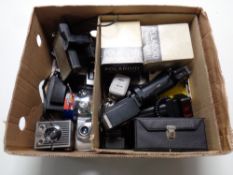 A box containing a quantity of vintage cameras and accessories to include Polaroid with boxed flash