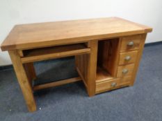 A contemporary oak computer desk fitted four drawers