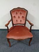A stained beech French style salon armchair upholstered in a pink button dralon
