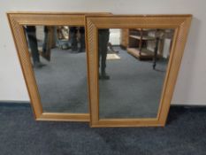 A pair of contemporary gilt waved framed bevel edged mirrors