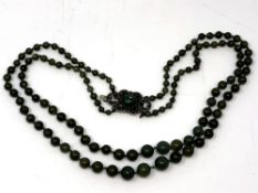 A double strand jade necklace on silver clasp