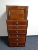 An Edwardian mahogany six drawer chest fitted cupboard above