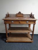 A 19th century oak marble topped three tier serving stand with gallery