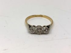An antique 18ct gold three stone diamond ring, the centre stone approximately 0.5 carat, size Q.