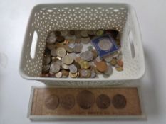 A basket containing assorted coinage to include a five piece Russian coin set in case,