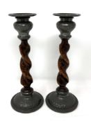 A pair of Arts & Crafts oak and pewter mounted candlesticks with sconces, height 22cm.