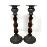 A pair of Arts & Crafts oak and pewter mounted candlesticks with sconces, height 22cm.