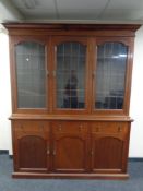 A 19th century mahogany triple door bookcase with leaded glass doors,
