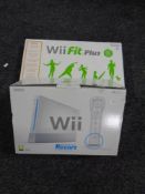 A Nintendo Wii Sports Resort console and game pack together with a Wii Fit +,