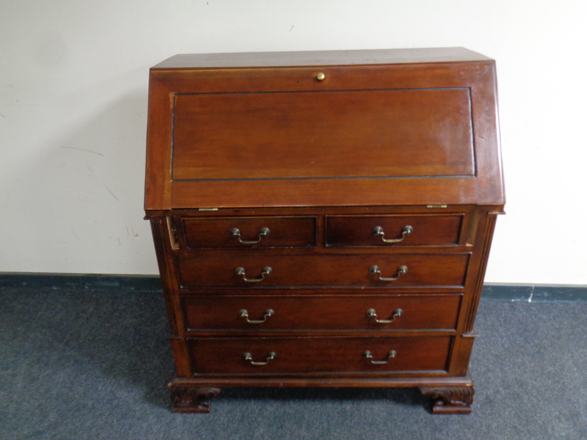 A reproduction Victorian style writing bureau fitted four drawers beneath