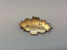 A Victorian brooch depicting a steam ship, engraved 'Mrs. W Gilroy Dec 31st 1897'.