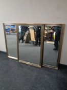 A set of three gilt framed bevel edged mirrors (as found)
