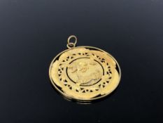 An old gold plated double sided pendant