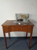 A 20th century Singer sewing machine in mahogany table