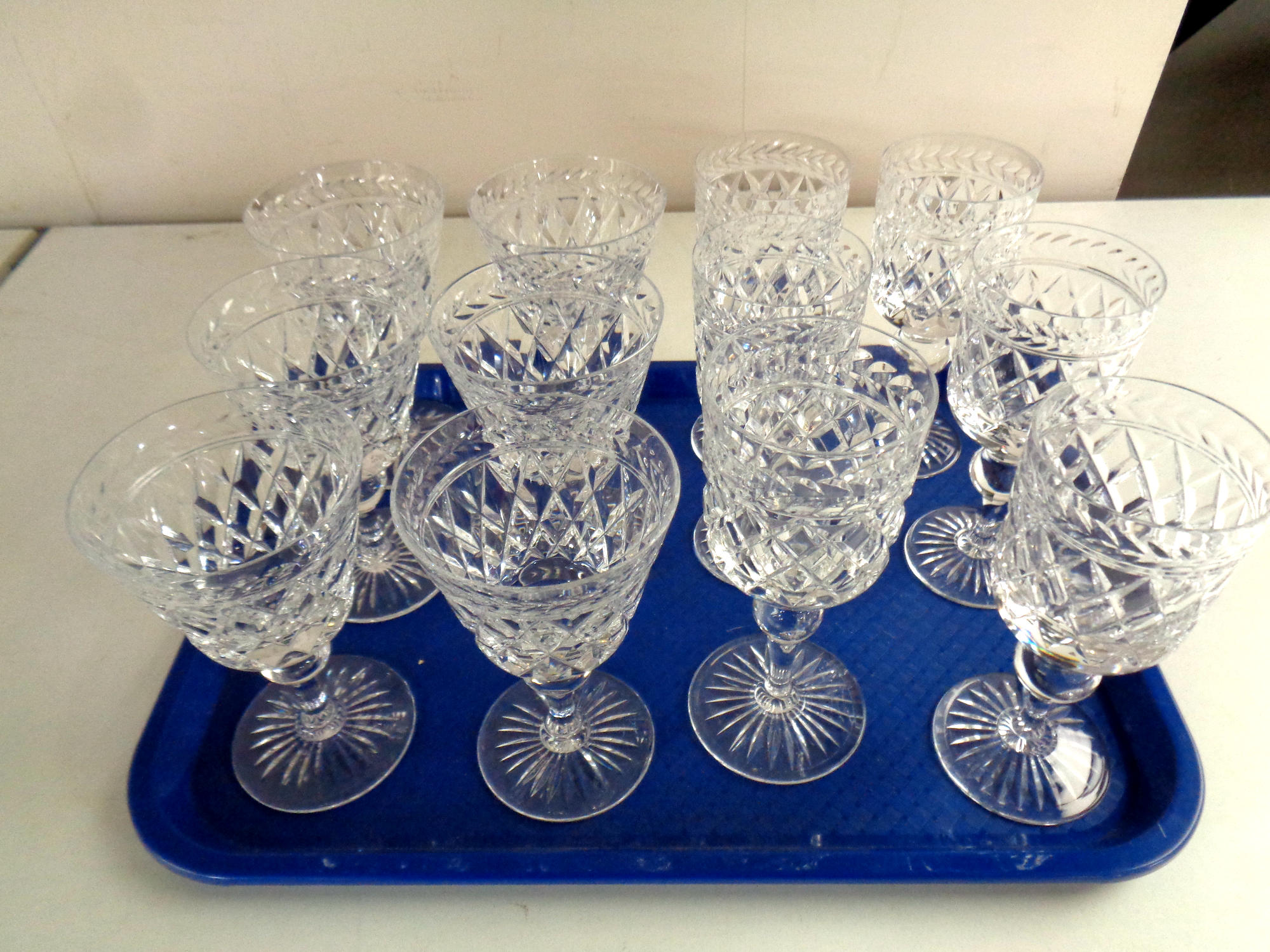 A tray containing two sets of six good quality lead crystal wine glasses