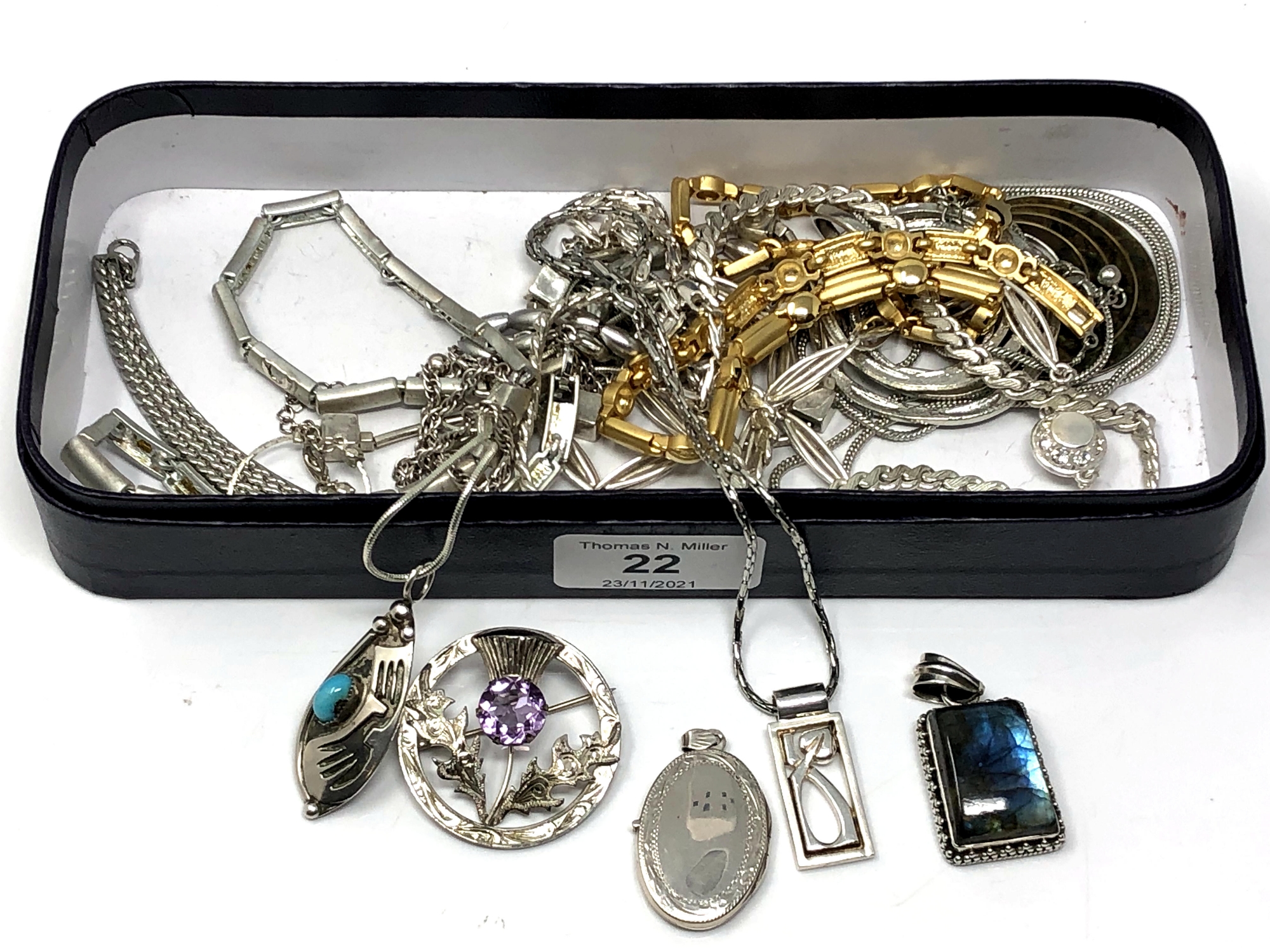 A box containing silver and white metal jewellery, Scottish silver brooch, silver locket etc.