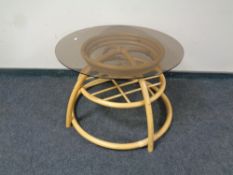 A contemporary circular bamboo and wicker glass topped conservatory coffee table