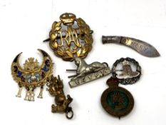 Military badges including silver Royal Artillery brooch, Ghurkas, RAF etc.