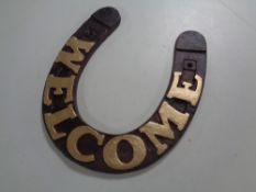 A cast iron Welcome horseshoe plaque