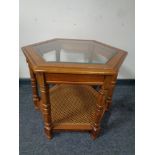 A hexagonal glass topped occasional table