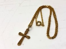 A 9ct gold crucifix pendant on plated chain. CONDITION REPORT: Crucifix weighs 1.1g.