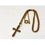 A 9ct gold crucifix pendant on plated chain. CONDITION REPORT: Crucifix weighs 1.1g.