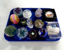 A tray containing ten assorted glass paperweights to include Caithness,