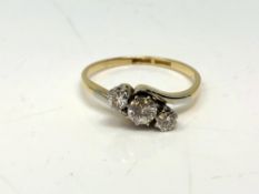 An 18ct gold three stone diamond ring, approx. 0.5 carat total, size O.