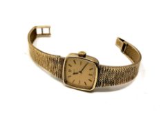 A lady's 9ct gold Omega wristwatch on 9ct gold integral bracelet.