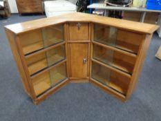 A set of mid 20th century corner bookshelves with sliding glass doors,