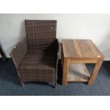 A rattan armchair and an occasional table in walnut finish