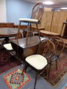 An oak gate leg table together with a set of five oak wheel back chairs