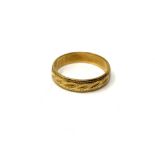 An 18ct gold band ring with engraved decoration, size L. CONDITION REPORT: 3.