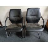 A pair of tubular metal and black vinyl office armchairs