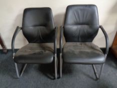 A pair of tubular metal and black vinyl office armchairs
