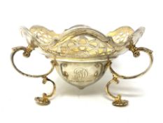 A good quality silver gilt pierced dish raised on shell pad feet