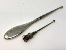 A silver-handled button hook and a 1902 coronation button hook.