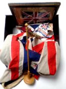 A box containing two union jack naval flags, handkerchief bearing flags,