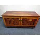 A double door sideboard in a rosewood finish 65 cm x 120 cm x 44 cm.