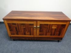 A double door sideboard in a rosewood finish 65 cm x 120 cm x 44 cm.