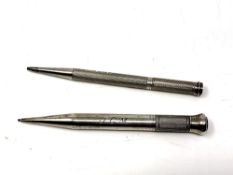 Two silver propelling pencils.